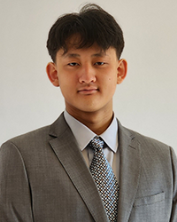 Photo of Maxwell Li. He has short dark hair and is wearing a grey suit jacket, a light grey shirt and a grey and white tie.